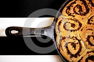 Detail of rolled bread buns with onion baked in pan