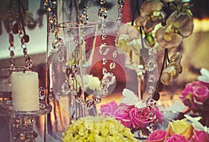 Detail of romantic table setting with flowers and candles