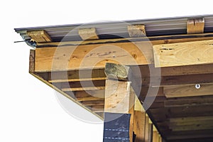 Detail of roofing construction on a new house. Wooden boards frame