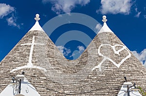 Detail of roofs and signs of the trulli houses, Alberobello town, Apulia region, Southern Italy