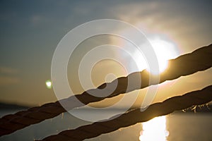 Detail of Ropes on Sailboat with Sunset in Background