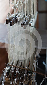 Detail of a rustic loom with cotton threads