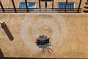 Detail of Rustic Southwestern stucco building with vigas and iron work