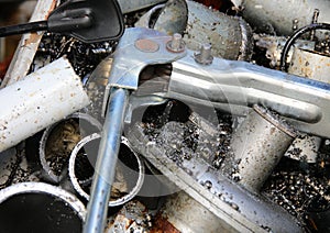 detail of rusty and broken iron and metal pieces in a landfill for the recycling photo