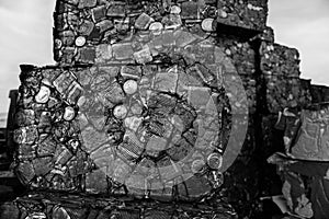 Detail of rusty can blocks compacted at a junkyard