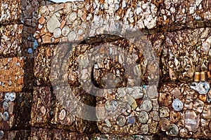 Detail of rusty can blocks compacted at a junkyard