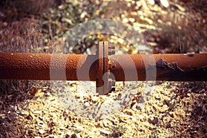 Detail of a rusty pipeline - concept image with vignette added