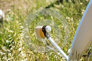 detail of satellite antenna in a meadow