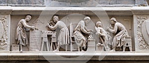 Detail of the sculptors and architects at work, bas-relief, Orsanmichele Church in Florence photo