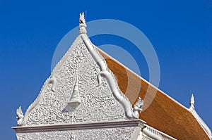 Detail of sculpture on white gable pediment part at Wat Supattanaram Worawihan public thai buddhist temple in Ubon Ratchathani Tha