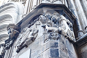 Detail of the sculptures of soldiers and phantasy animals on the facade of a Medieval church in the Gothic Quarter of Barcelona