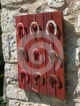 Detail of a set of old horseshoes hanging on a board 2.