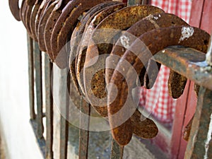 Detail of several old horseshoes hanging from a window 2.