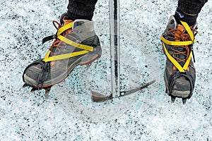 Detail of shoes with crampons and ice axe Glacier walk in Iceland