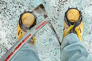 Detail of shoes with crampons and ice axe. Glacier walk ,Iceland