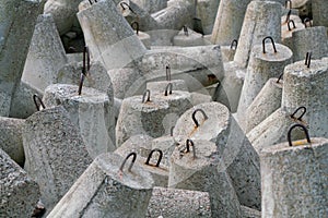 Detail shot of concrete tetrapod dolosse breakwater with steel eyes protecting the port of Hel, Poland from ocean tides