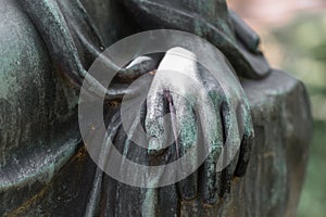 Detail shot of a female hand of a bronze statue of a woman in a park, Germany