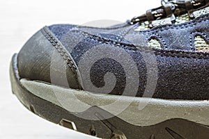 Detail shot of fragmrnt of new fashionable hiking mountain boot.