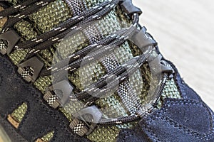 Detail shot of fragmrnt of new fashionable hiking mountain boot.