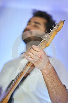 Detail shot of guitarist playing instrument