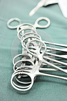 Detail shot of steralized surgery instruments with a hand grabbing a tool