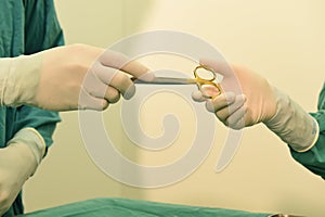 Detail shot of steralized surgery instruments with a hand grabbing a tool