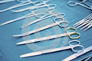 Detail shot of steralized surgery instruments with a hand grabbing a tool