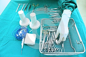 Detail shot of steralized surgery instruments with a hand grabbing a tool photo