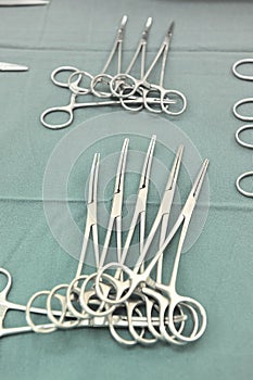 Detail shot of steralized surgery instruments with a hand grabbing a tool