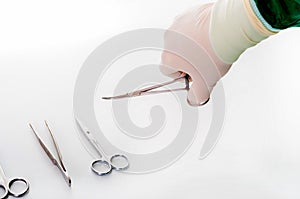 Detail shot of steralized surgery instruments with a hand grabbing a tool