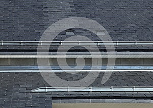 Detail of a slate roof of a house with gutter