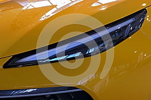 Detail of sleek elegant LED headlight of modern chinese compact crossover SUV car