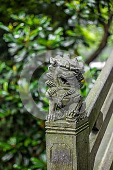 Detail of a small chinese lion sculpture on a stone bridge in a park in Wenzhou in China - 1