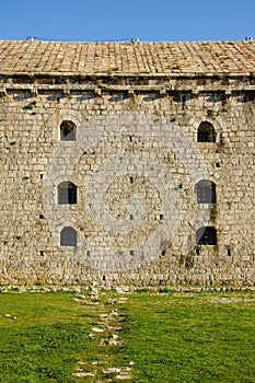 Detail of the small windows on a wall of an ancient castle Rozafa, Shkoder, Albania
