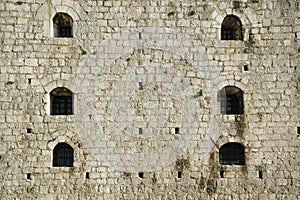 Detail of the small windows on a wall of an ancient castle Rozafa, Shkoder, Albania