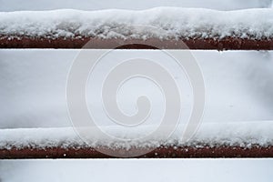 Detail of a snow-covered industrial stair railing in winter