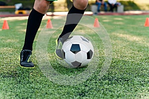 Detail soccer player kicking ball on field. Soccer players on training session. Detail soccer background. Close up of