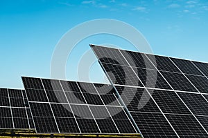 detail of solar panels in photovoltaic solar park under blue sky