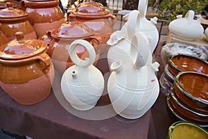 Closeup of some botijos and ceramic jugs in a traditional market photo