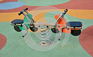 Detail of some of the swings for children in a playground photo