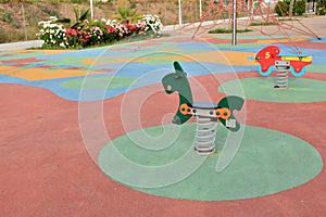 Detail of some of the swings for children in a playground photo