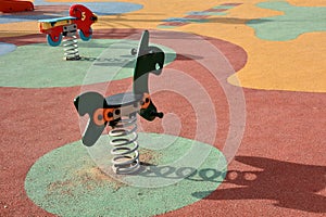 Detail of some of the swings for children in a playground photo