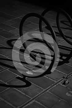 Detail of a spiral support for bicycles, shot in black and white