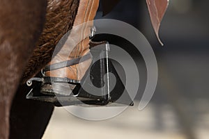 Detail of the spur, stirrup and boot of a Doma Vaquera rider photo