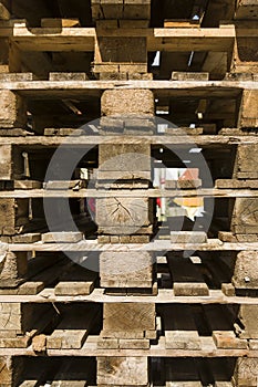 Detail of a stack of empty returnable wooden pallets in Euronorm