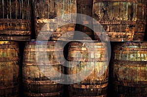 Detail of stacked old wooden whisky barrels photo