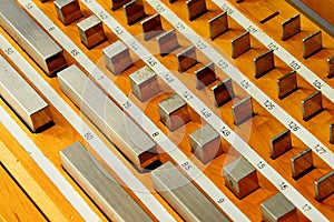 Detail of stainless steel rectangular gauge block metric etalons placed in wooden case