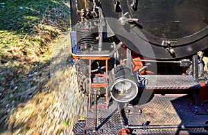 Detail of a steam locomotive while driving. Dynamics through motion blur