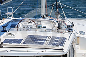 detail of steering wheel and navigation instruments of a sailboat