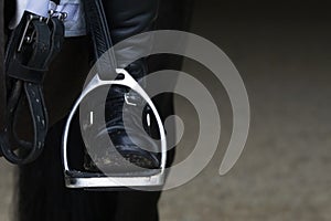 Detail of a stirrup and boot in dressage